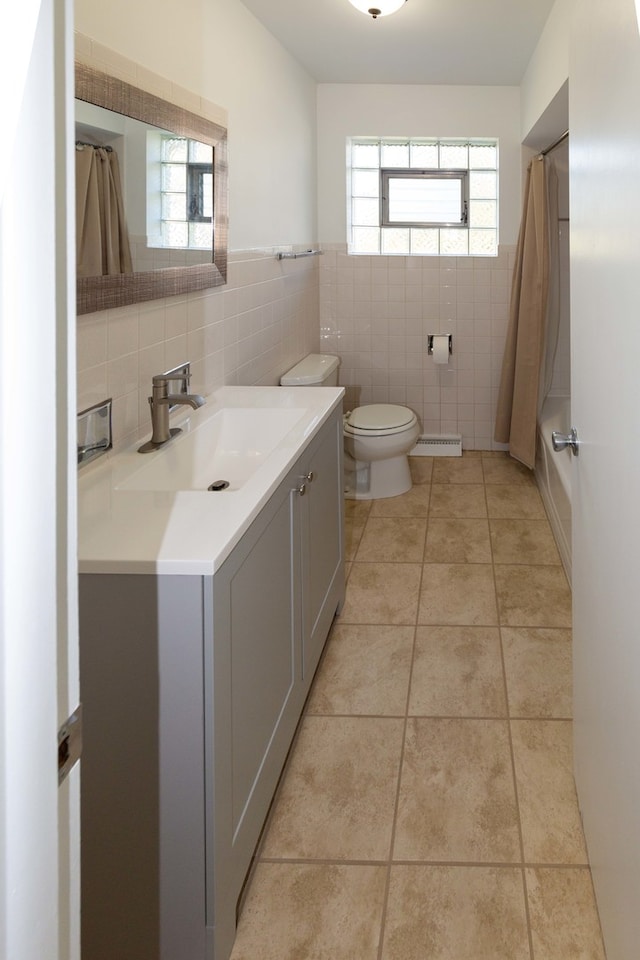 full bathroom with vanity, tile patterned flooring, toilet, and plenty of natural light