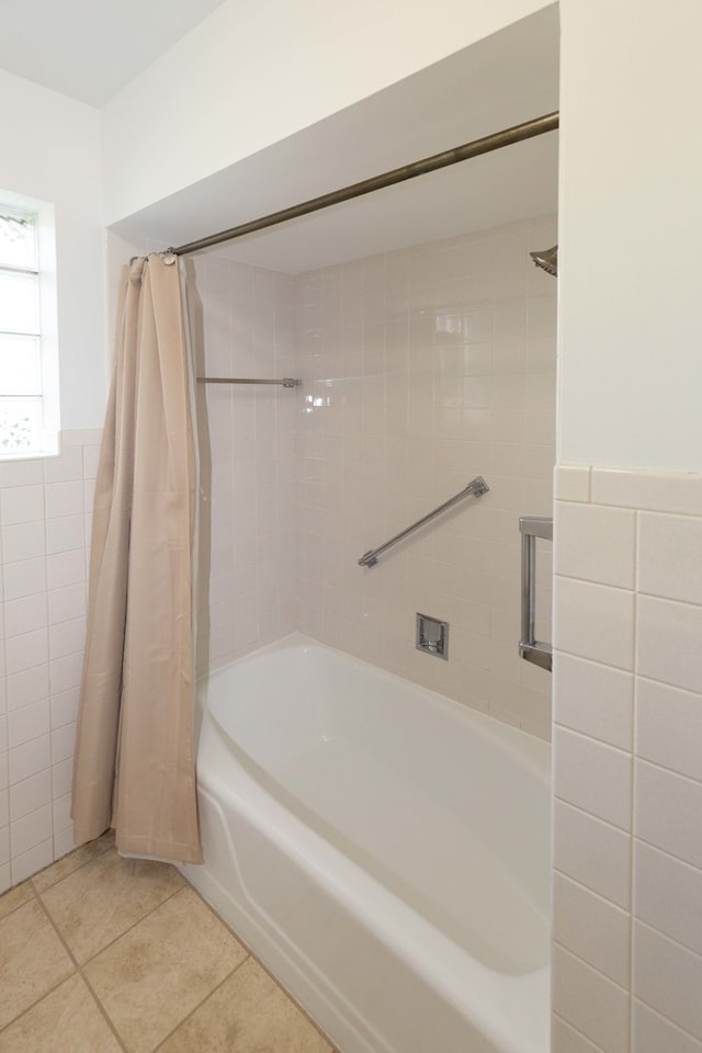 bathroom featuring tile walls, shower / tub combo, and tile patterned flooring