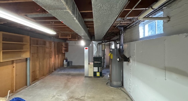 basement featuring water heater and heating unit