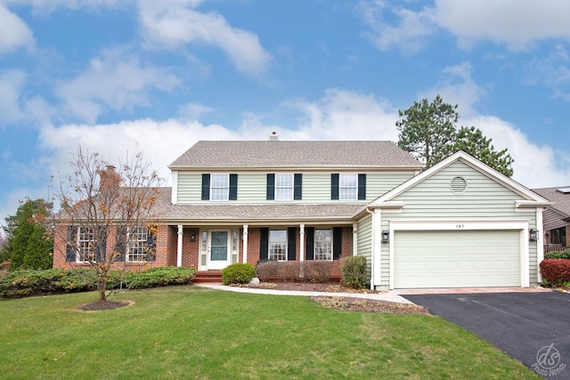 front of property with a front lawn and a garage