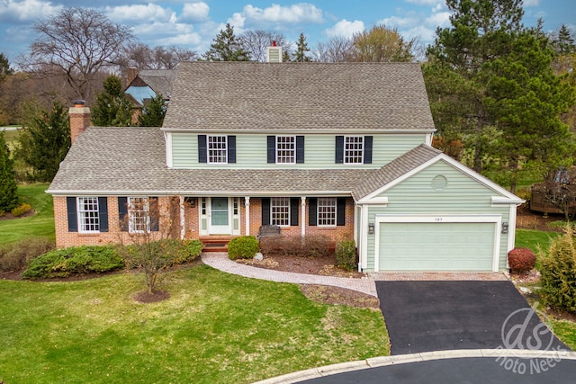 view of front of home with a front yard and a garage