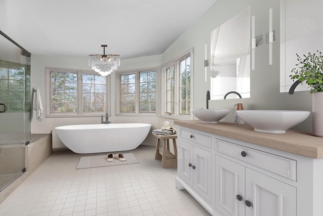 bathroom featuring vanity, shower with separate bathtub, a notable chandelier, and tile patterned floors