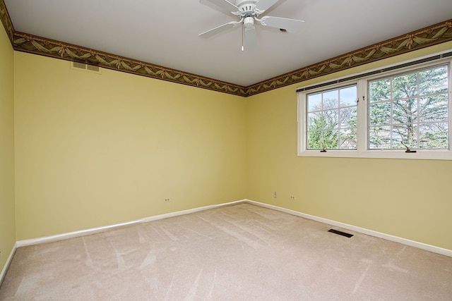 unfurnished room featuring ceiling fan and carpet