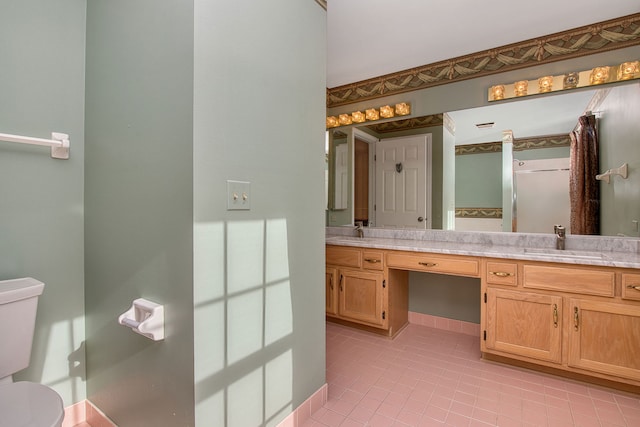 bathroom with tile patterned floors, vanity, and toilet