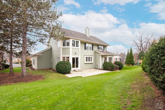 rear view of property with a lawn and a patio