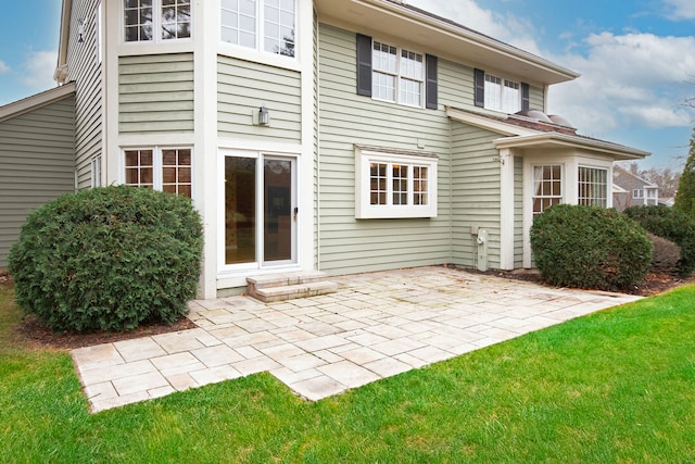 rear view of property with a patio area and a yard