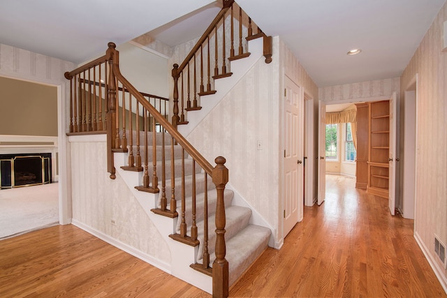 stairs featuring wood-type flooring