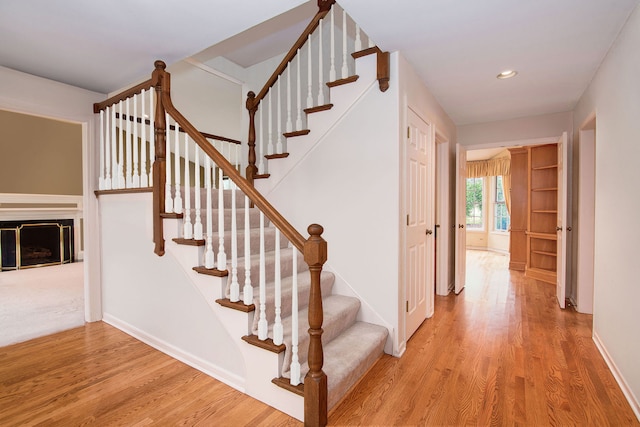 stairway with hardwood / wood-style floors