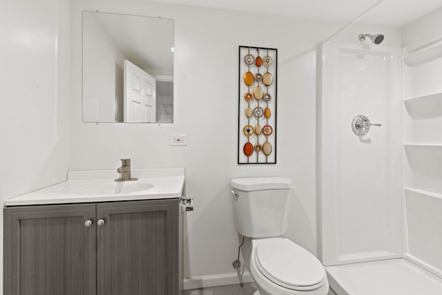 bathroom featuring vanity, a shower, and toilet