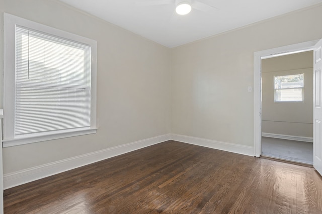 spare room featuring dark hardwood / wood-style flooring and ceiling fan