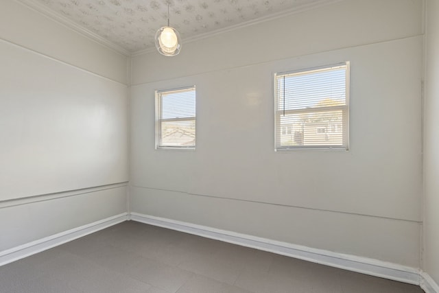 unfurnished room with ornamental molding and a healthy amount of sunlight