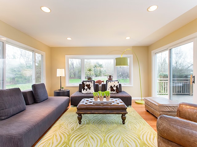 living room featuring light wood-type flooring and a healthy amount of sunlight