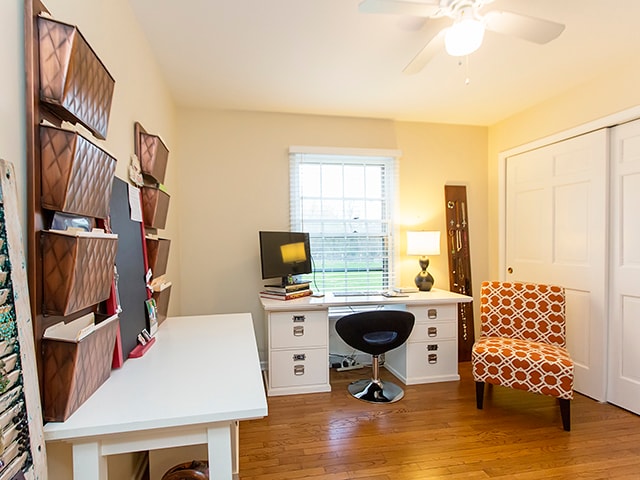 office with hardwood / wood-style flooring and ceiling fan