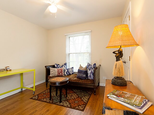 sitting room with dark hardwood / wood-style floors and ceiling fan