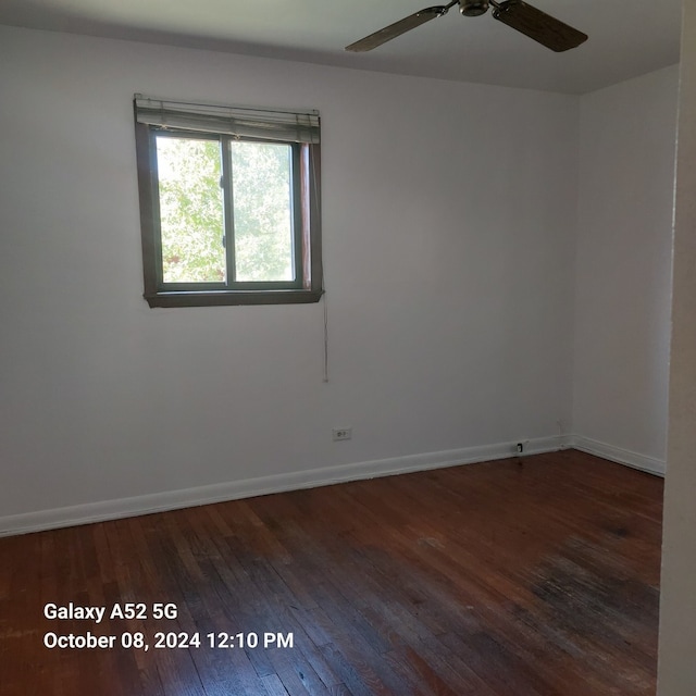 spare room featuring ceiling fan and dark hardwood / wood-style flooring