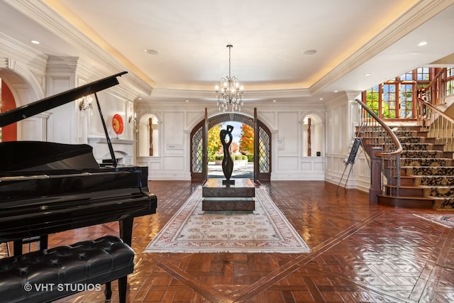 misc room with dark parquet flooring, a tray ceiling, crown molding, and a notable chandelier