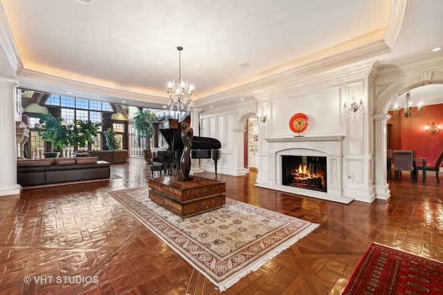 interior space featuring dark parquet floors, ornamental molding, ornate columns, a tray ceiling, and a chandelier