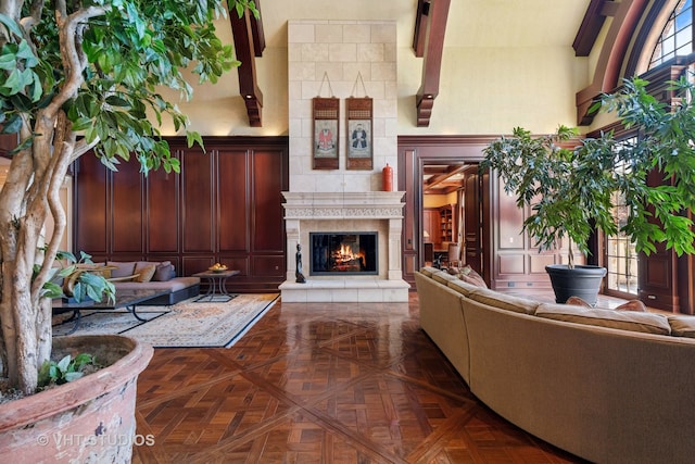 living room featuring dark parquet floors and lofted ceiling with beams