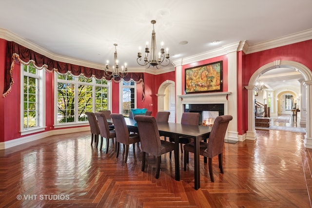 dining space with a wealth of natural light, crown molding, a notable chandelier, and parquet flooring