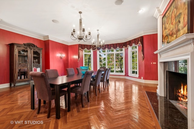 dining space with crown molding, parquet flooring, a fireplace, and a chandelier