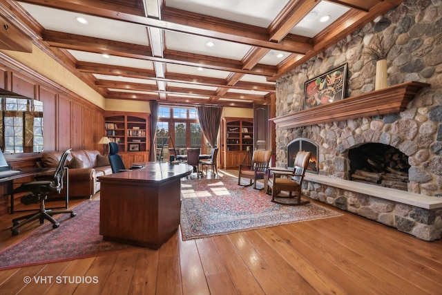 office area featuring a fireplace, wood-type flooring, beamed ceiling, and coffered ceiling