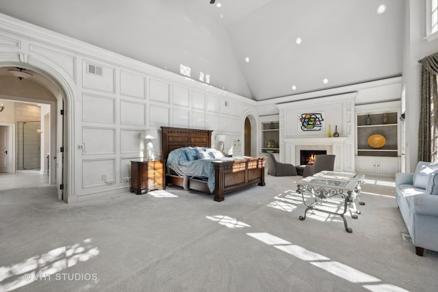 carpeted bedroom featuring high vaulted ceiling