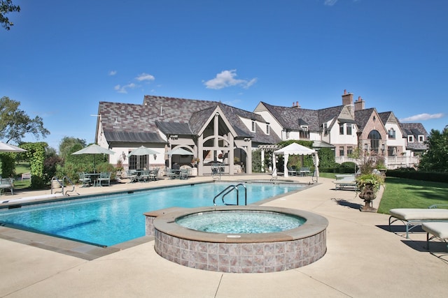 view of swimming pool with a community hot tub and a patio