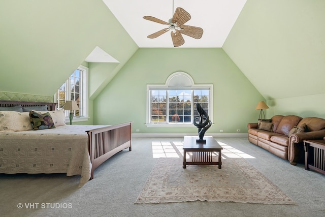 bedroom with ceiling fan, vaulted ceiling, and multiple windows