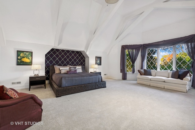 carpeted bedroom with beamed ceiling and high vaulted ceiling