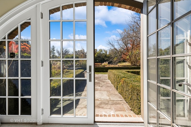 entryway featuring french doors and vaulted ceiling