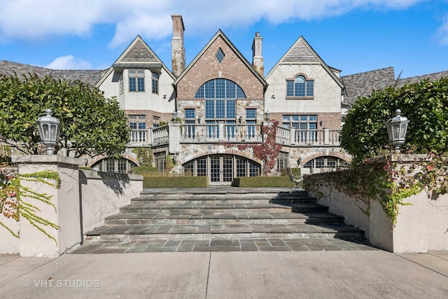 exterior space with a balcony and french doors