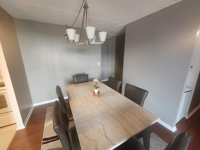 dining room featuring dark hardwood / wood-style floors and a chandelier