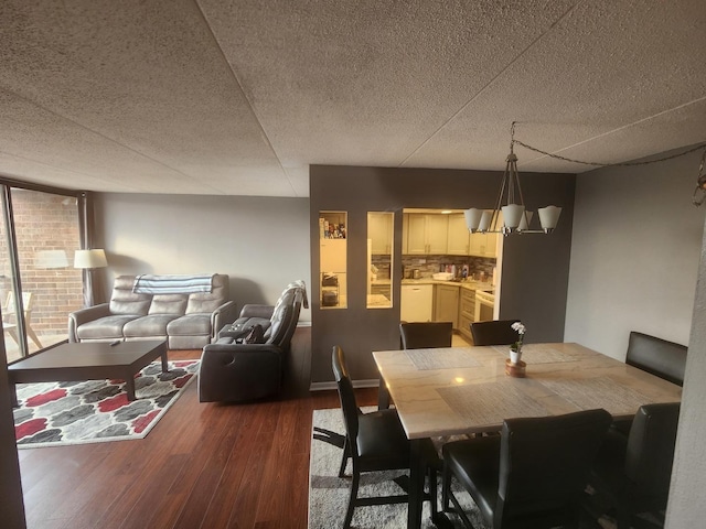 dining space with hardwood / wood-style flooring and a chandelier