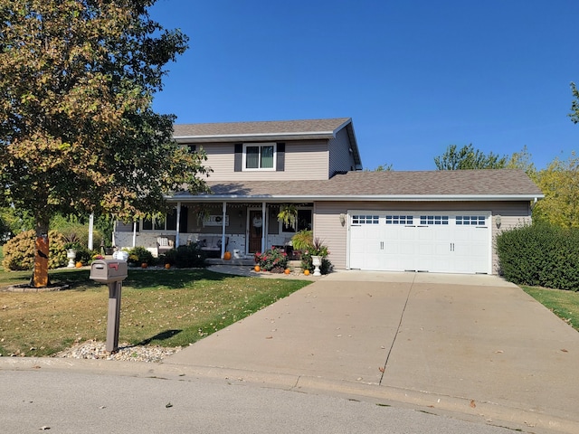 view of front facade featuring a front lawn, covered porch, and a garage