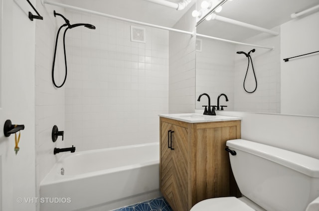 full bathroom with vanity, tiled shower / bath combo, and toilet