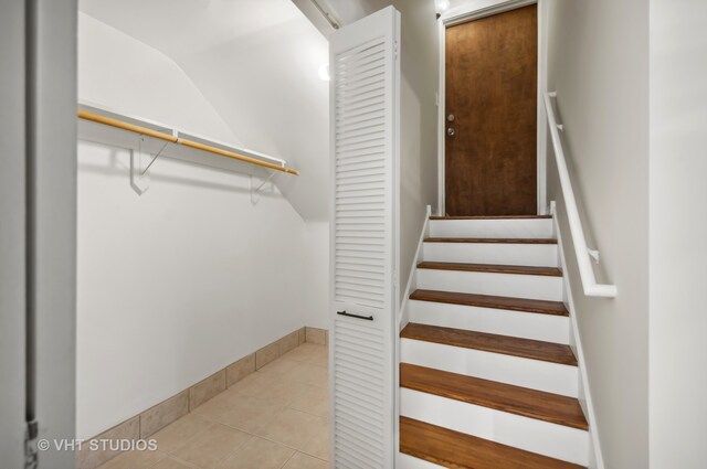 stairway with tile patterned flooring