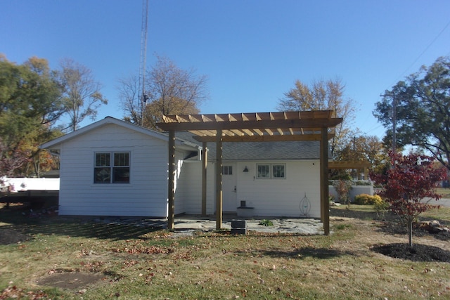 rear view of house featuring a patio area and a lawn