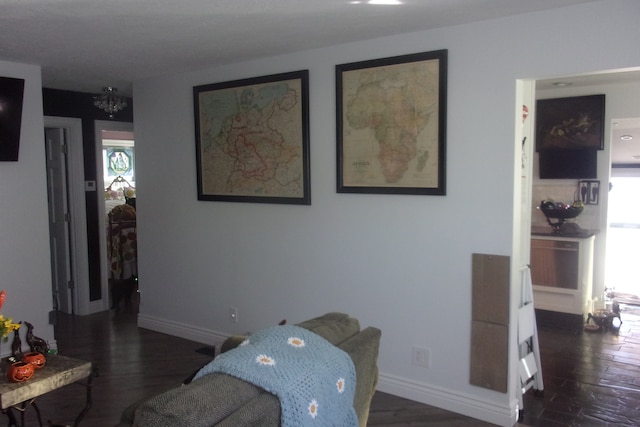 living room with a wealth of natural light and dark hardwood / wood-style flooring