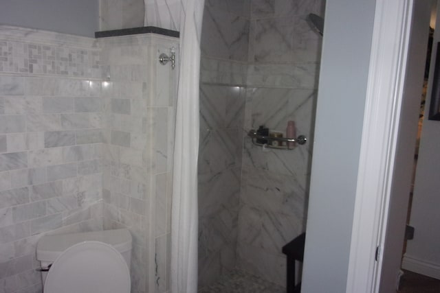 bathroom with toilet and walk in shower