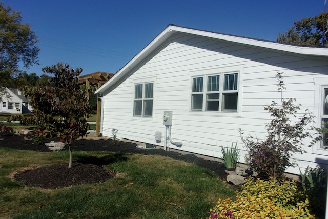 view of property exterior with a lawn