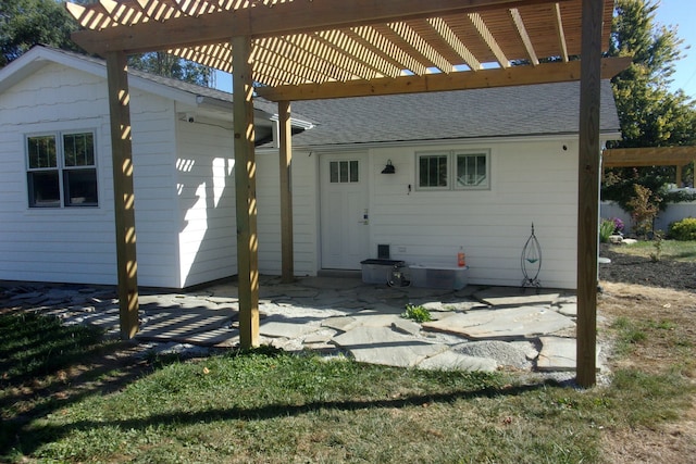 back of property featuring a patio area and a pergola