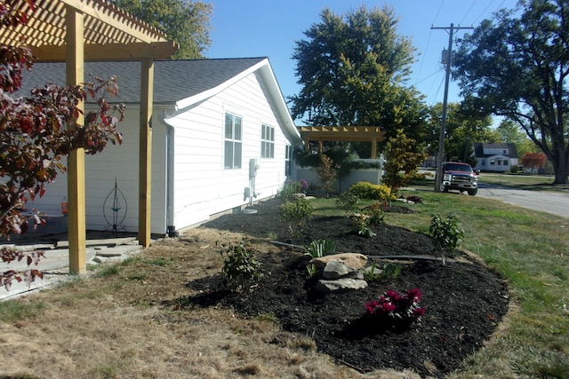 view of property exterior with a yard and a pergola