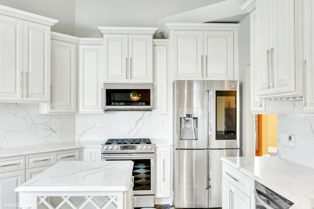 kitchen featuring appliances with stainless steel finishes, light stone countertops, decorative backsplash, and white cabinetry