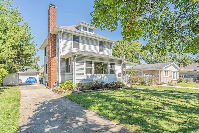 front of property with an outdoor structure, a front yard, and a garage