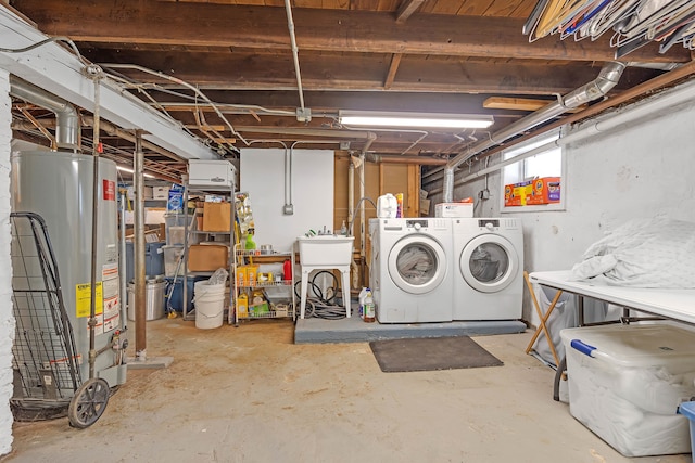 basement featuring water heater and separate washer and dryer