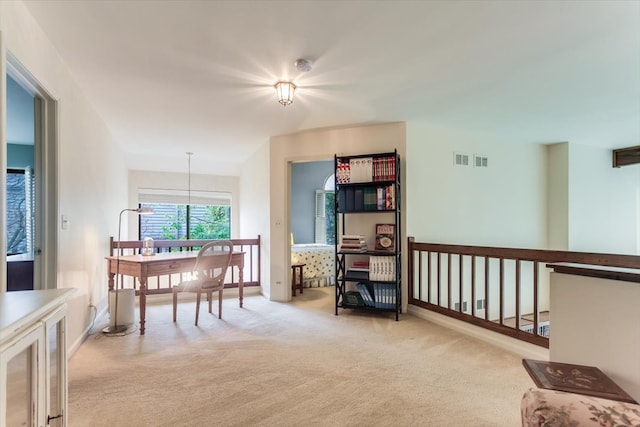 living area featuring a chandelier and light colored carpet