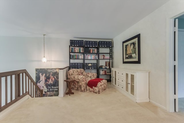 living area featuring light carpet