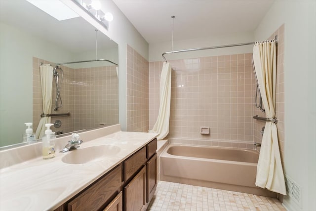 bathroom featuring vanity and shower / bath combination with curtain