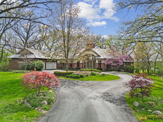 132 N Wynstone Dr, North Barrington, IL 60010 - view of front of property featuring curved driveway, brick siding, an attached garage, and a front lawn