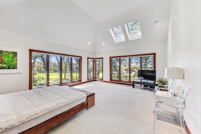 carpeted bedroom with a skylight, high vaulted ceiling, and multiple windows